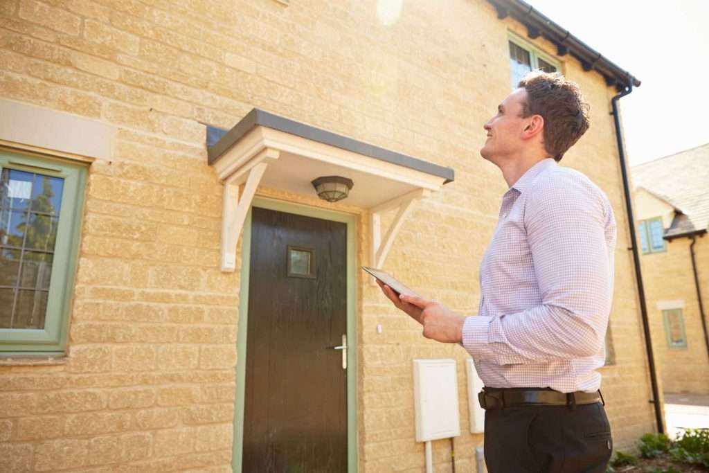 Surveyor presenting report to property buyers